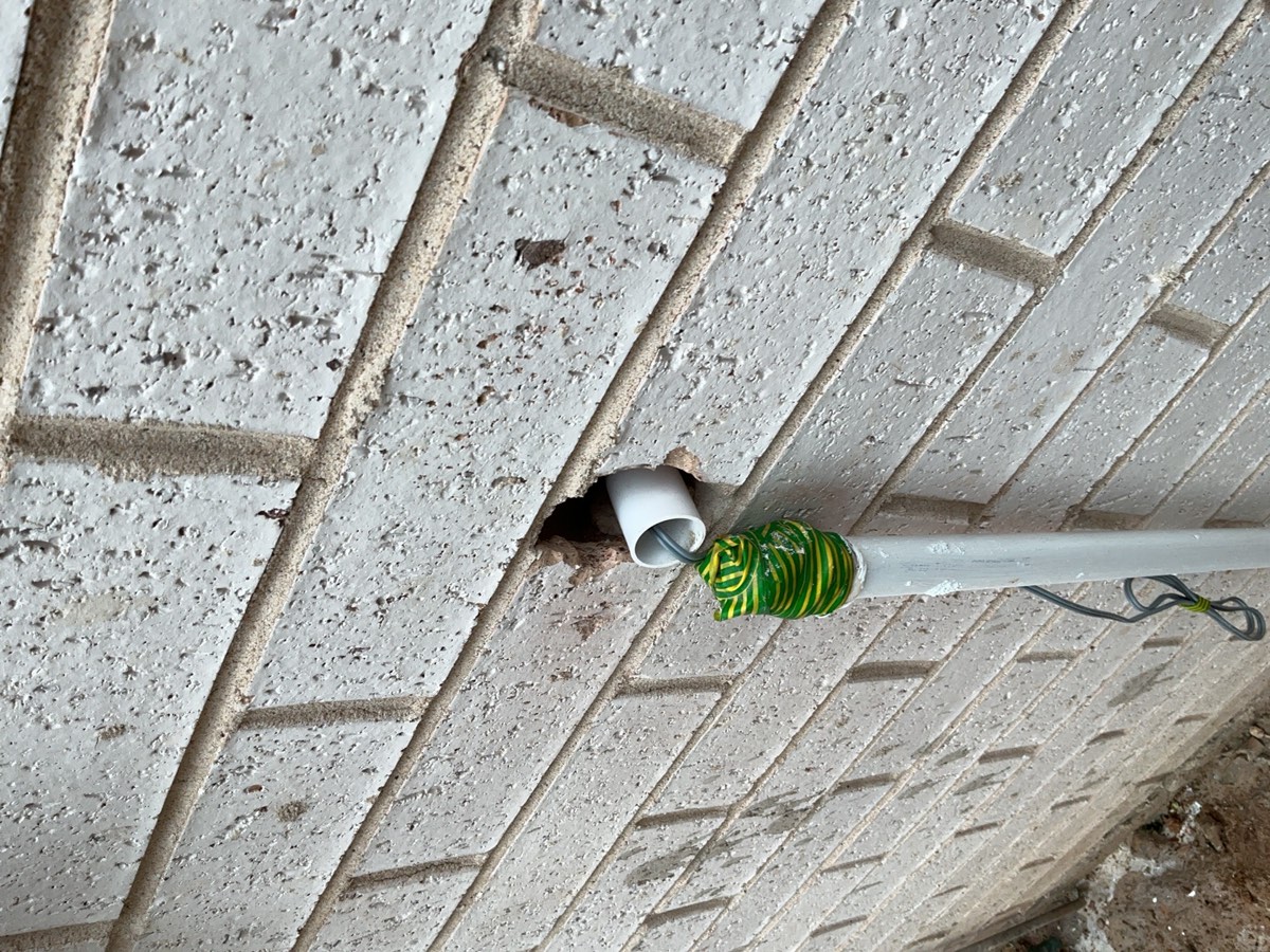 The hole where the pipe goes through the wall